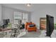 Bright home office with large windows, comfortable seating, and a functional desk setup for productivity at 325 Buckhorn Branch Park, Clayton, NC 27520