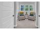 Bright sitting area with two armchairs, three windows, and neutral decor at 325 Buckhorn Branch Park, Clayton, NC 27520