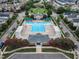 Community pool and clubhouse with shaded seating areas at 327 Commons Walk Cir, Cary, NC 27519