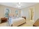 Neutral primary bedroom with a bed, two side tables and the door to the ensuite bathroom at 327 Commons Walk Cir, Cary, NC 27519