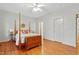 Spacious bedroom with wood floors, four poster bed and white walls at 327 Commons Walk Cir, Cary, NC 27519