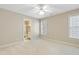 Neutral bedroom with a view of an ensuite bathroom and a window with natural light at 327 Commons Walk Cir, Cary, NC 27519