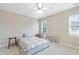 Cozy bedroom with neutral walls, ceiling fan, and natural lighting coming from the window at 327 Commons Walk Cir, Cary, NC 27519