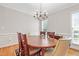 Cozy dining room with wood table and cushioned chairs on hardwood floors at 327 Commons Walk Cir, Cary, NC 27519