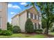 Charming two-story home boasting a brick and siding exterior, well-manicured landscaping, and a cozy front porch at 327 Commons Walk Cir, Cary, NC 27519