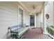 Inviting front porch with comfortable bench seating and charming architectural details at 327 Commons Walk Cir, Cary, NC 27519