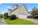 Spacious two-car garage with lush landscaping, offering privacy and curb appeal at 327 Commons Walk Cir, Cary, NC 27519