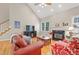 Bright living room with fireplace, hardwood floors and natural light at 327 Commons Walk Cir, Cary, NC 27519