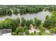 Aerial view of a tranquil pond featuring a gazebo surrounded by trees and greenery at 327 Commons Walk Cir, Cary, NC 27519