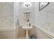 Stylish powder room with unique wallpaper and pedestal sink at 327 Commons Walk Cir, Cary, NC 27519