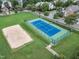 Community tennis courts and sand volleyball court in a green space at 327 Commons Walk Cir, Cary, NC 27519