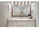 Bathroom featuring white vanity, speckled countertop, and large mirror at 3285 Edinburgh Dr, Sanford, NC 27332