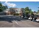 Clubhouse featuring brick accents, multiple windows, outdoor seating and parking for numerous golf carts at 3285 Edinburgh Dr, Sanford, NC 27332