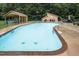 Well-maintained community pool area featuring chairs and shelters at 3285 Edinburgh Dr, Sanford, NC 27332