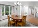 Bright dining room with a wood table, large window, patterned rug, and traditional decor at 3285 Edinburgh Dr, Sanford, NC 27332
