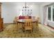 Dining room featuring a wood table, chairs, patterned rug, and a large window providing natural light at 3285 Edinburgh Dr, Sanford, NC 27332