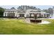 Stately home featuring manicured lawn, circular drive, and decorative fountain at 3285 Edinburgh Dr, Sanford, NC 27332