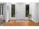Bright foyer with hardwood floors, white trim, sidelight windows, and a neutral-colored rug at 3285 Edinburgh Dr, Sanford, NC 27332