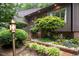 Exterior of a home showcasing lush landscaping and a brick walkway leading to the entrance at 3285 Edinburgh Dr, Sanford, NC 27332