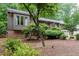 Exterior of a home featuring lush landscaping, a well-manicured lawn, and a side-entry two-car garage at 3285 Edinburgh Dr, Sanford, NC 27332