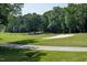 Beautiful golf course featuring a large sand trap, smooth green grass, and mature trees at 3285 Edinburgh Dr, Sanford, NC 27332