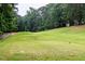Scenic view of the community golf course featuring mature trees and green grass at 3285 Edinburgh Dr, Sanford, NC 27332