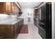 Modern kitchen features stainless steel appliances, sleek cabinets, and a contrasting red patterned rug at 3285 Edinburgh Dr, Sanford, NC 27332