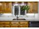 Bright kitchen features a copper sink with a view from the window and wooden cabinets at 3285 Edinburgh Dr, Sanford, NC 27332