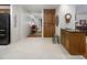 Spacious kitchen features tile flooring, wooden cabinets, a wet bar, and access to other living spaces at 3285 Edinburgh Dr, Sanford, NC 27332
