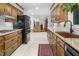 Bright kitchen featuring stainless steel appliances, wooden cabinets, and a charming view into other living spaces at 3285 Edinburgh Dr, Sanford, NC 27332