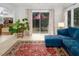 Inviting living room with a comfortable blue sofa, patterned curtains, and seamless access to the outdoor deck at 3285 Edinburgh Dr, Sanford, NC 27332