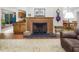 Cozy living room with a fireplace, classic decor, and views into the kitchen and dining areas at 3285 Edinburgh Dr, Sanford, NC 27332
