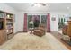 Comfortable living room featuring a plush armchair, patterned rug, and views of the outdoor patio at 3285 Edinburgh Dr, Sanford, NC 27332