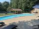 A community pool with a covered gazebo, tennis courts, and lounge chairs for relaxation at 3285 Edinburgh Dr, Sanford, NC 27332