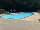 A refreshing community pool with lounge chairs for relaxing and umbrellas for shade at 3285 Edinburgh Dr, Sanford, NC 27332