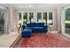 Bright sunroom with large windows and a comfortable blue sofa for relaxing at 3285 Edinburgh Dr, Sanford, NC 27332