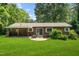 View of the home's exterior with a large backyard and patio at 330 Wilmot Dr, Raleigh, NC 27606