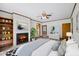 Bedroom featuring new floors, neutral paint, ceiling fan and a decorative fireplace at 330 Wilmot Dr, Raleigh, NC 27606