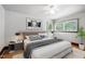 This staged bedroom features a large window, ceiling fan, and stylish decor at 330 Wilmot Dr, Raleigh, NC 27606
