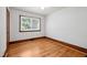 This bedroom features a window and a classic hardwood floor at 330 Wilmot Dr, Raleigh, NC 27606