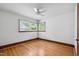 This bedroom features hardwood floors, a window, and a ceiling fan at 330 Wilmot Dr, Raleigh, NC 27606