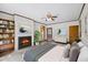A staged bedroom featuring new floors, neutral paint, ceiling fan and a decorative fireplace at 330 Wilmot Dr, Raleigh, NC 27606