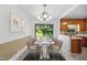 Staged dining area featuring a modern table, seating for eight, and views to the backyard at 330 Wilmot Dr, Raleigh, NC 27606