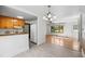 Open floor plan kitchen featuring white appliances, wood cabinets, and easy access to the living room at 330 Wilmot Dr, Raleigh, NC 27606