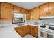 Bright kitchen features knotty pine cabinetry, a stainless steel sink, and ample counter space, bringing the outdoors in at 330 Wilmot Dr, Raleigh, NC 27606