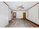 Empty living room featuring new floors, neutral paint, ceiling fan and a view into the kitchen at 330 Wilmot Dr, Raleigh, NC 27606