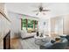 Staged living room with comfortable seating, a fireplace, and natural light at 330 Wilmot Dr, Raleigh, NC 27606