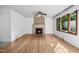Spacious living room featuring gleaming hardwood floors, a fireplace, and large window at 330 Wilmot Dr, Raleigh, NC 27606