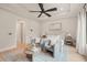 A serene main bedroom featuring a seating area, neutral tones, and a plush king-sized bed at 343 Rainforest Pl, Apex, NC 27523