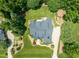 Aerial view showcasing the roof and the surrounding lush green landscape and mature trees at 3728 Westbury Lake Dr, Raleigh, NC 27603